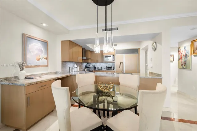 a view of a dining room with furniture wooden floor and chandelier