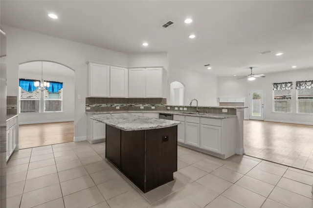 a kitchen with stainless steel appliances granite countertop a stove and a sink