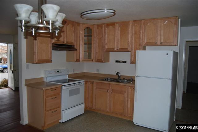 1095 Akard Drive Reno, NV 89503 - Photo 2 of 9 a kitchen with a sink a stove and cabinets