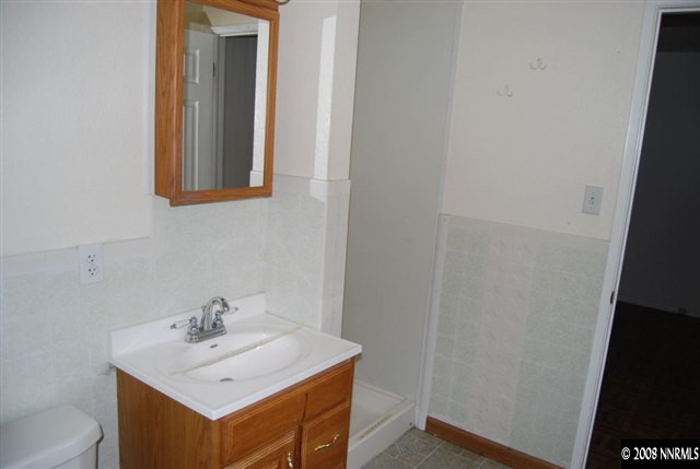 1095 Akard Drive Reno, NV 89503 - Photo 6 of 9 a bathroom with a sink and a mirror