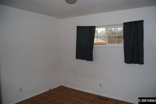 1095 Akard Drive Reno, NV 89503 - Photo 7 of 9 a view of an empty room with wooden floor and a window