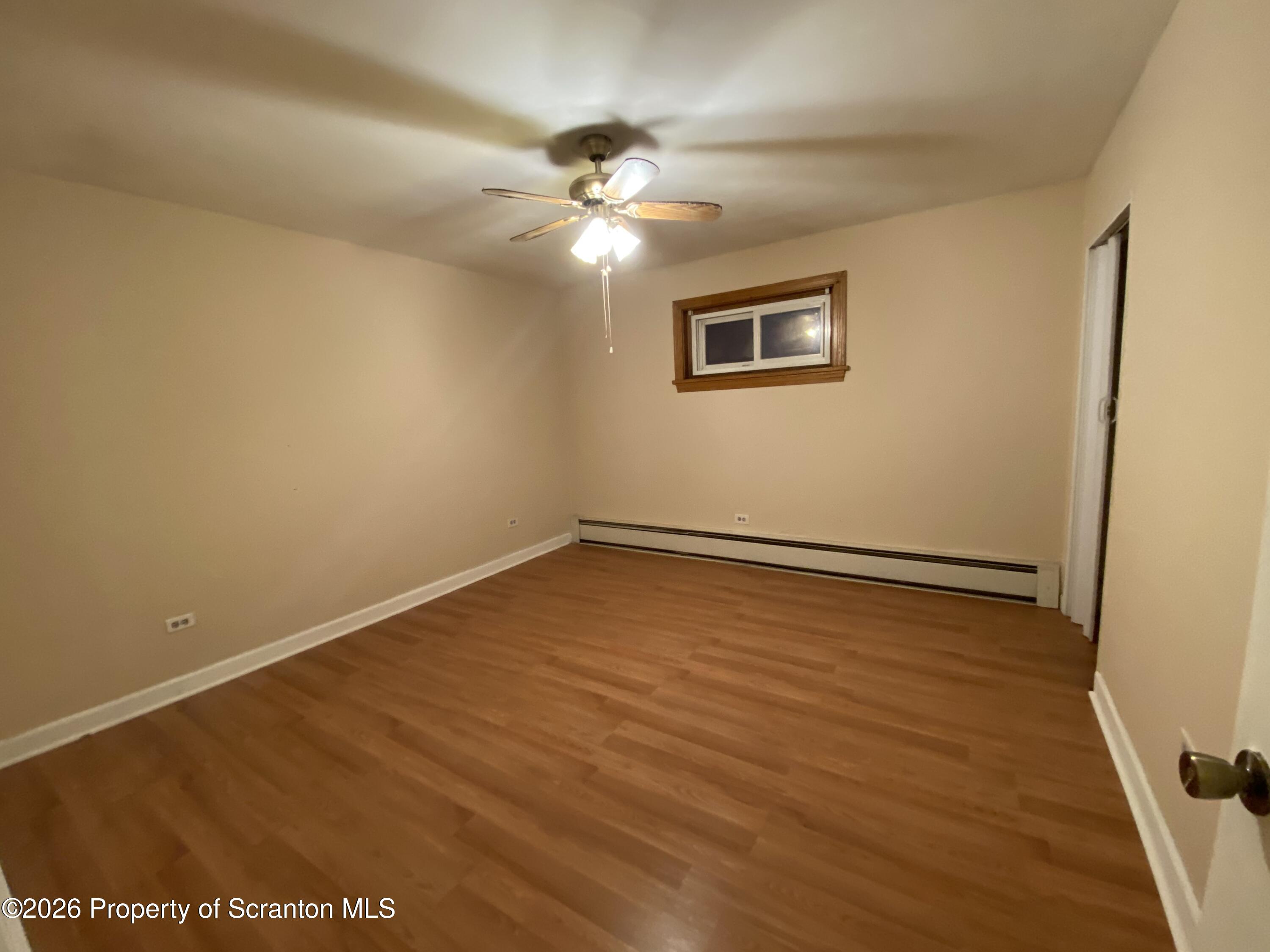 414 Orchard Street Scranton, PA 18505 - Photo 11 of 20 a view of an empty room with wooden floor and a window