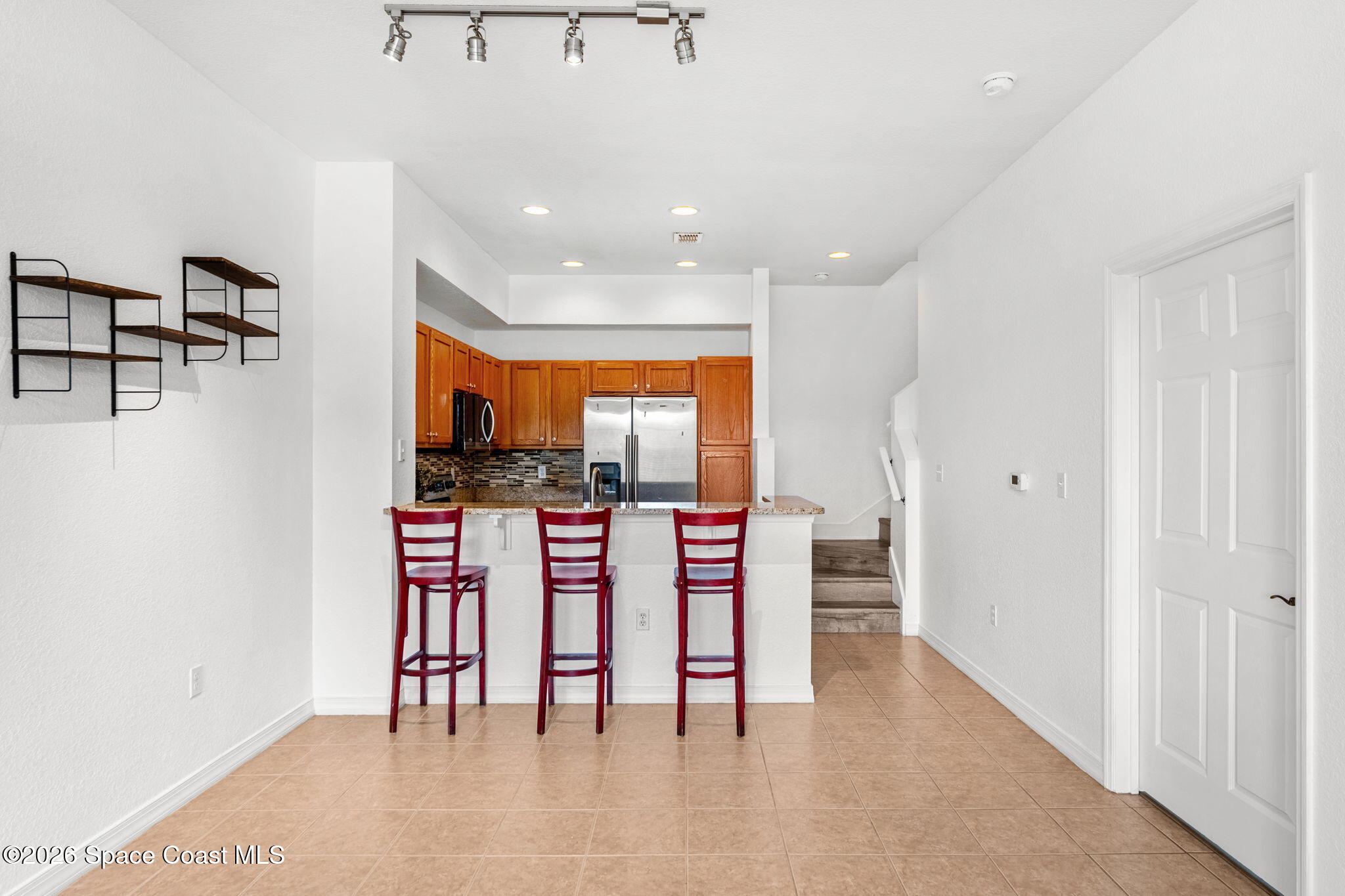 110 Turpial Way, Unit 106 Melbourne, FL 32901 - Photo 14 of 50 a dining room with furniture and a floor to ceiling window