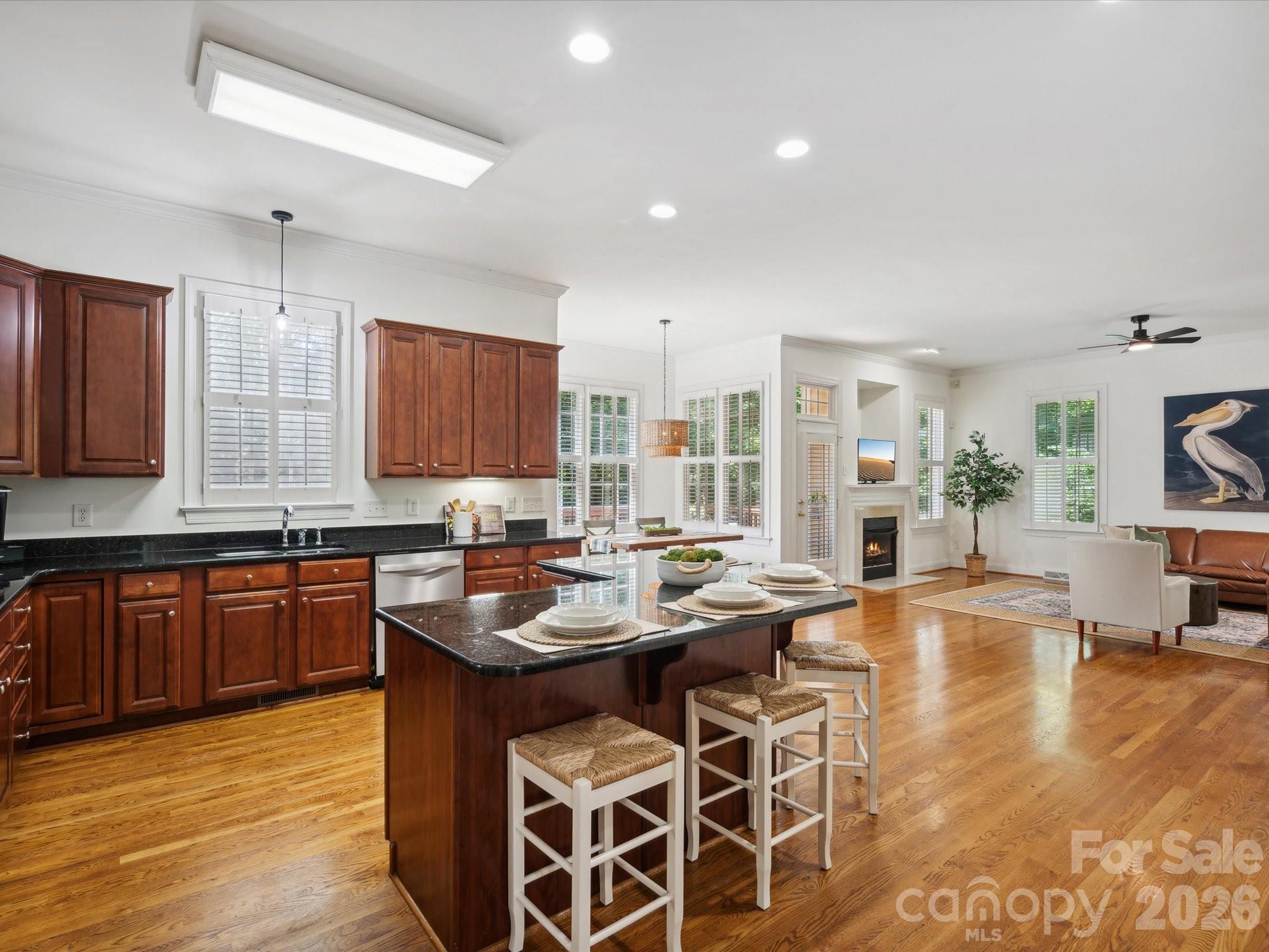 927 Derick's Crossing Fort Mill, SC 29708 - Photo 20 of 48 a kitchen with stainless steel appliances granite countertop wooden cabinets a stove and a sink