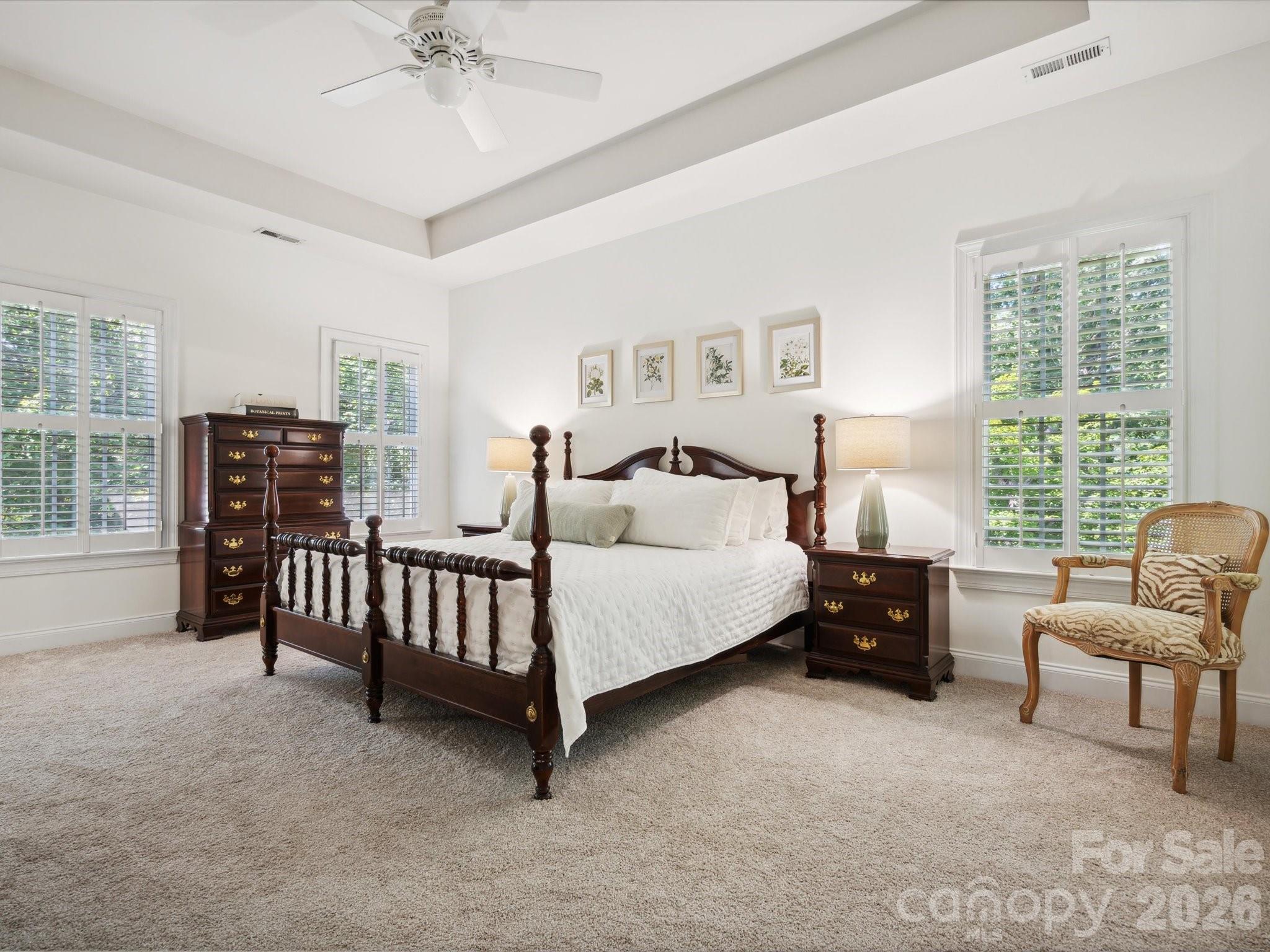 927 Derick's Crossing Fort Mill, SC 29708 - Photo 27 of 48 a spacious bedroom with a bed and a chandelier