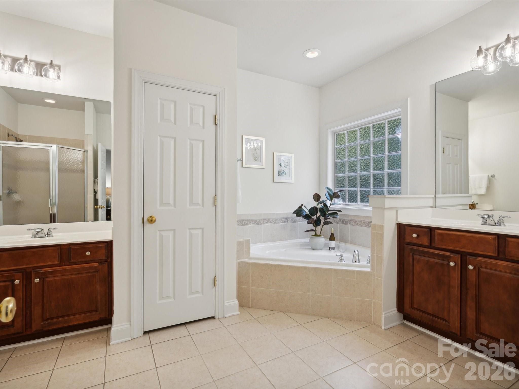 927 Derick's Crossing Fort Mill, SC 29708 - Photo 28 of 48 a bathroom with a tub sink and mirror