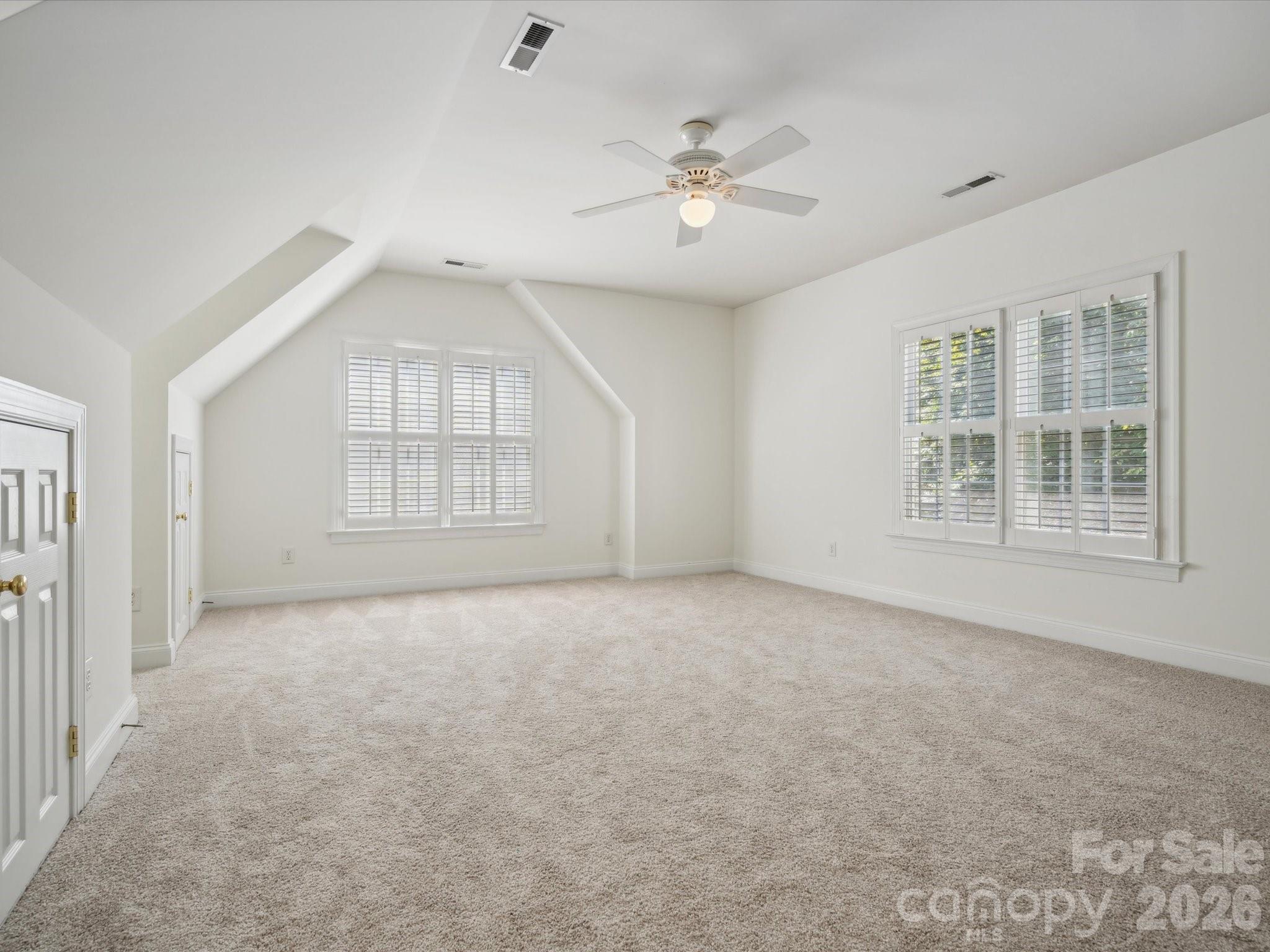 927 Derick's Crossing Fort Mill, SC 29708 - Photo 35 of 48 an empty room with windows and chandelier fan
