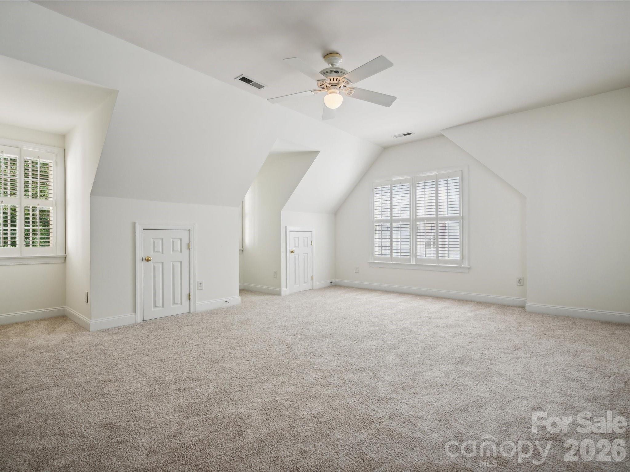 927 Derick's Crossing Fort Mill, SC 29708 - Photo 36 of 48 an empty room with windows and ceiling fan