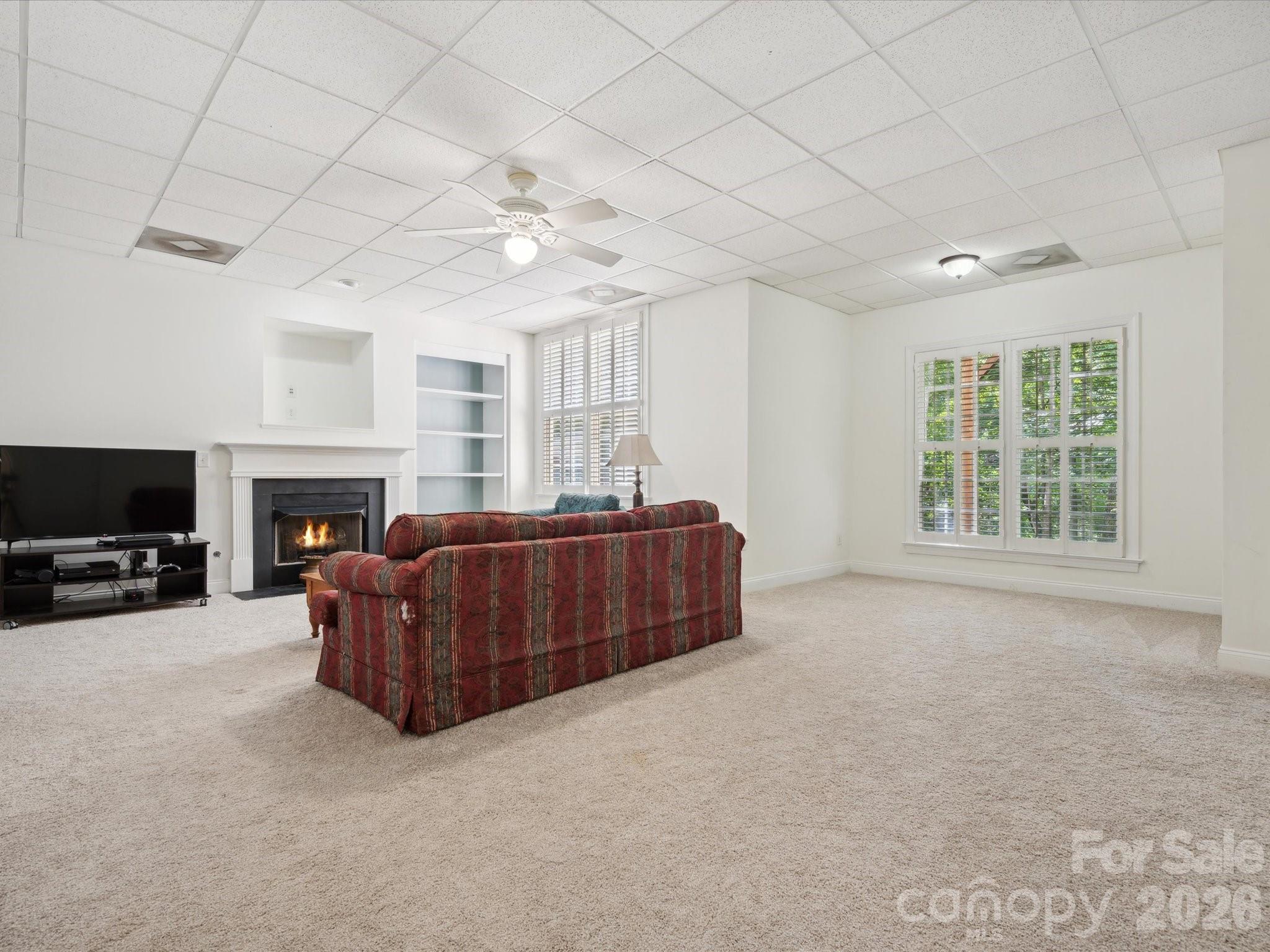 927 Derick's Crossing Fort Mill, SC 29708 - Photo 40 of 48 a living room with furniture a fireplace and a flat screen tv