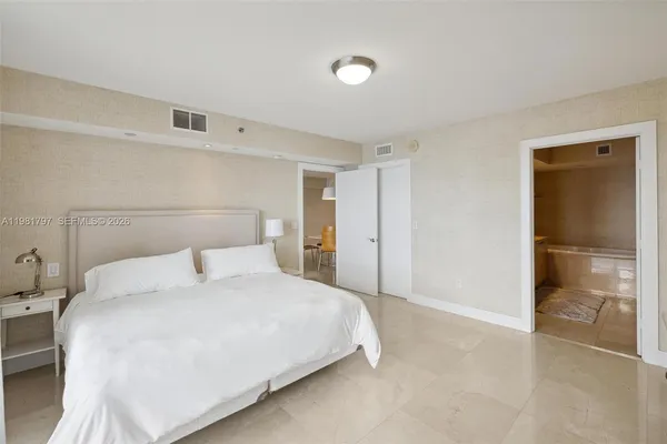 a bedroom with a bed and a walk in closet