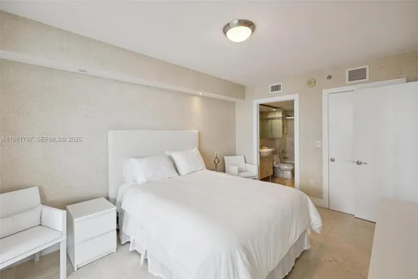 a bedroom with a bed and a couch