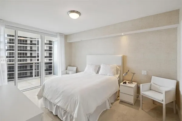 a bedroom with a bed and a chair