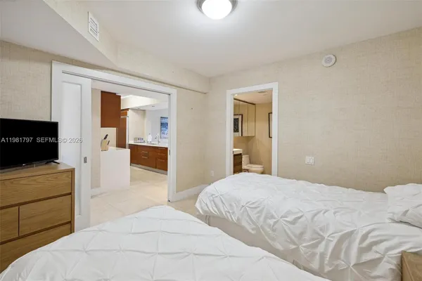 a bedroom with a bed and a television