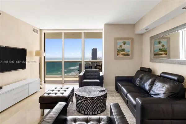 a living room with furniture and a flat screen tv