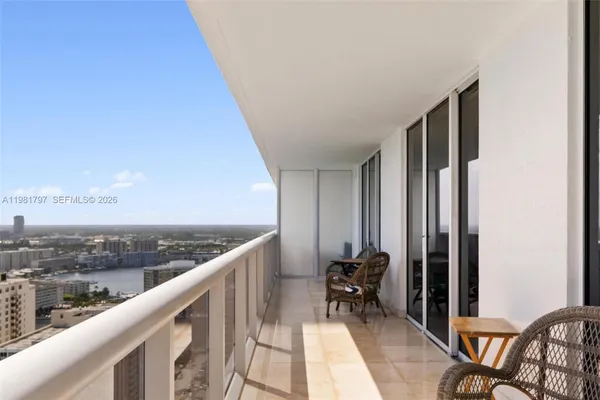 a balcony with table and chairs