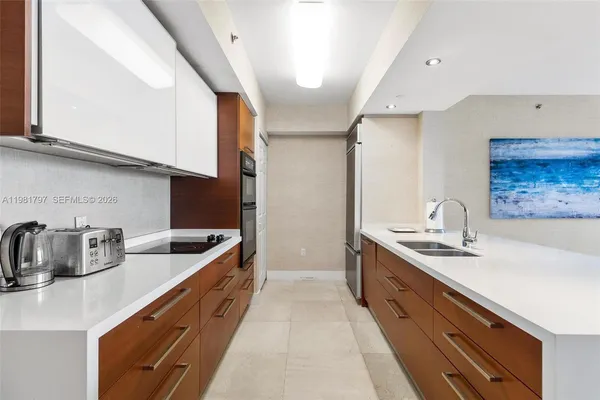 a kitchen with stainless steel appliances a sink stove and cabinets