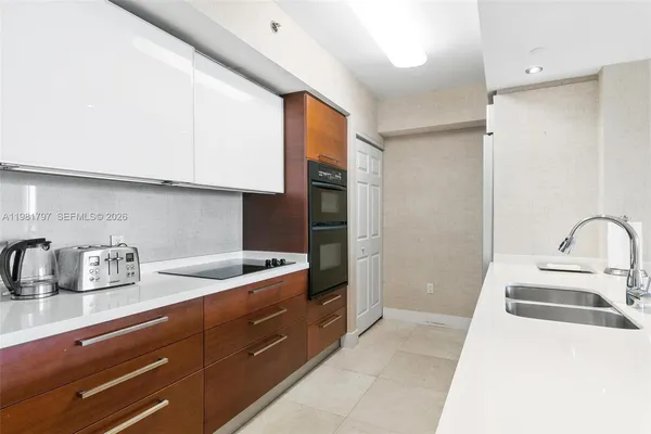 a kitchen with a sink and refrigerator