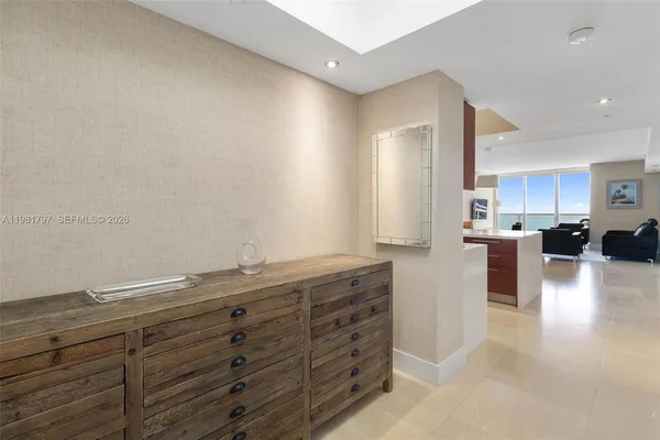 a kitchen with granite countertop white cabinets and stainless steel appliances