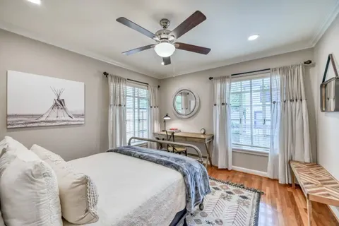 a bedroom with a large bed and a window