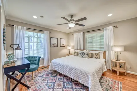 a bedroom with a bed a table and chair