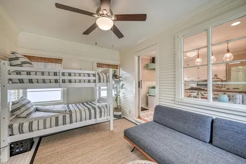 a bedroom with furniture and a large window