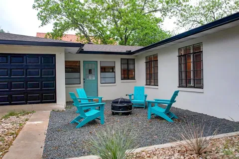 a backyard of a house with barbeque oven