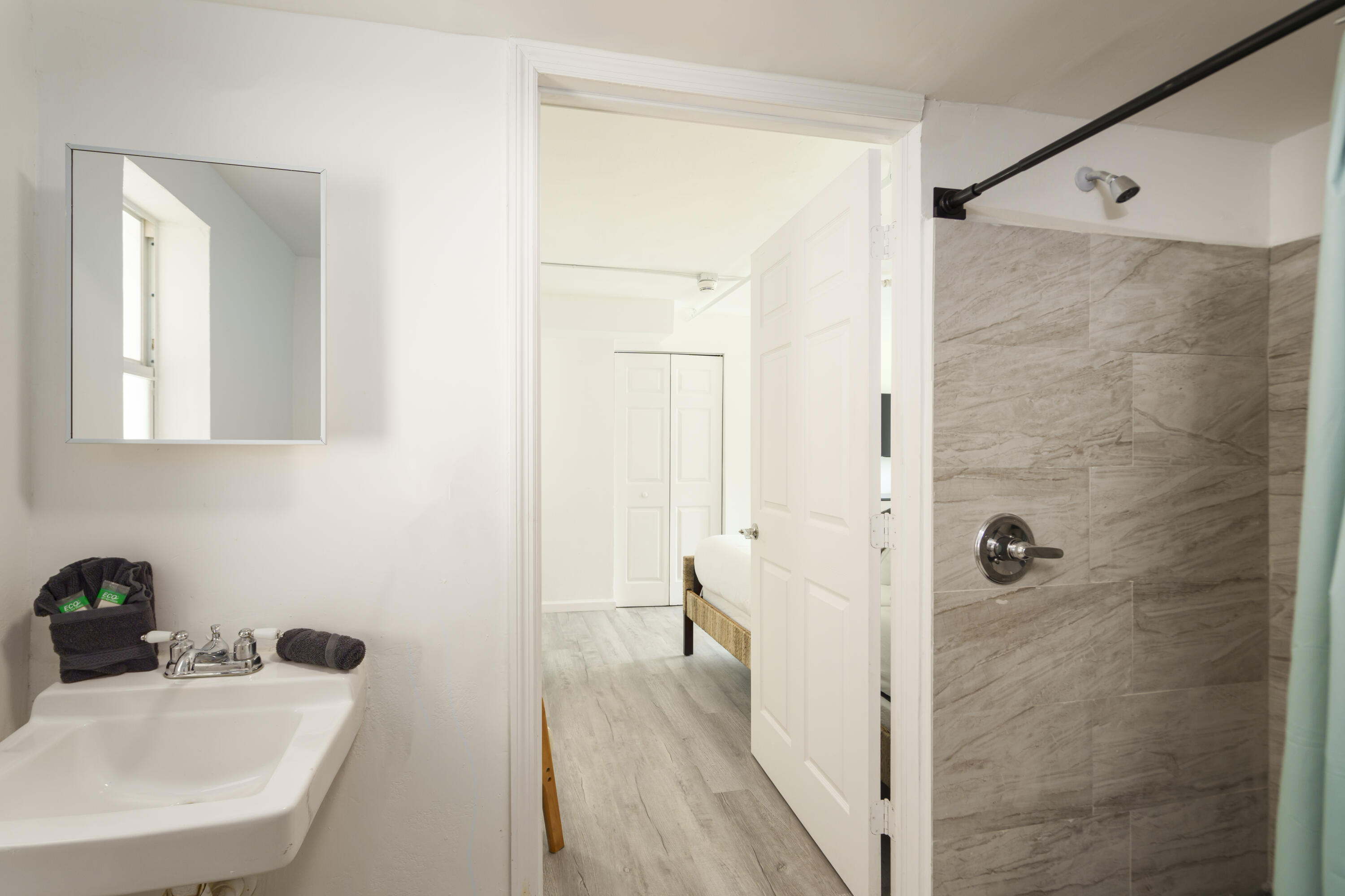 1020 North Riverside Drive, Unit 2 Pompano Beach, FL 33062 - Photo 7 of 14 a bathroom with a sink a mirror and shower