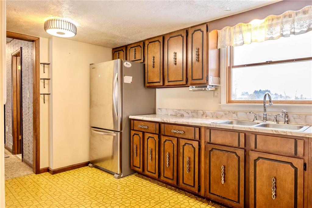 1142 Apples Mill Road West Newton, PA 15089 - Photo 11 of 32 a kitchen with stainless steel appliances granite countertop a refrigerator and a sink