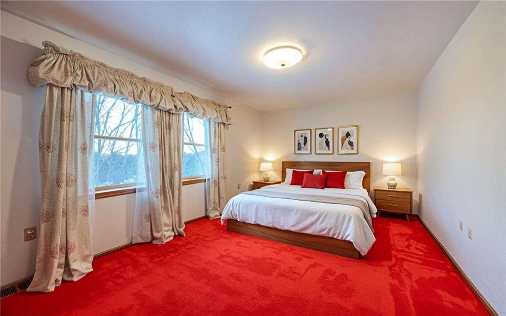 1142 Apples Mill Road West Newton, PA 15089 - Photo 18 of 32 a bedroom with a large bed and a chandelier