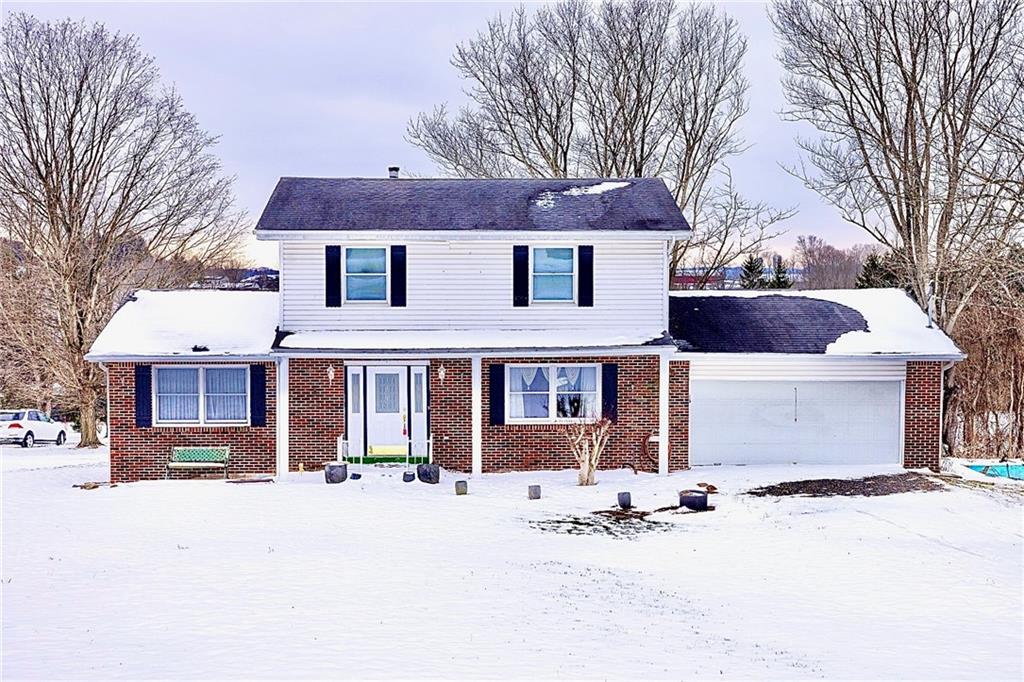 1142 Apples Mill Road West Newton, PA 15089 - Photo 2 of 32 a front view of a house with a yard covered with snow