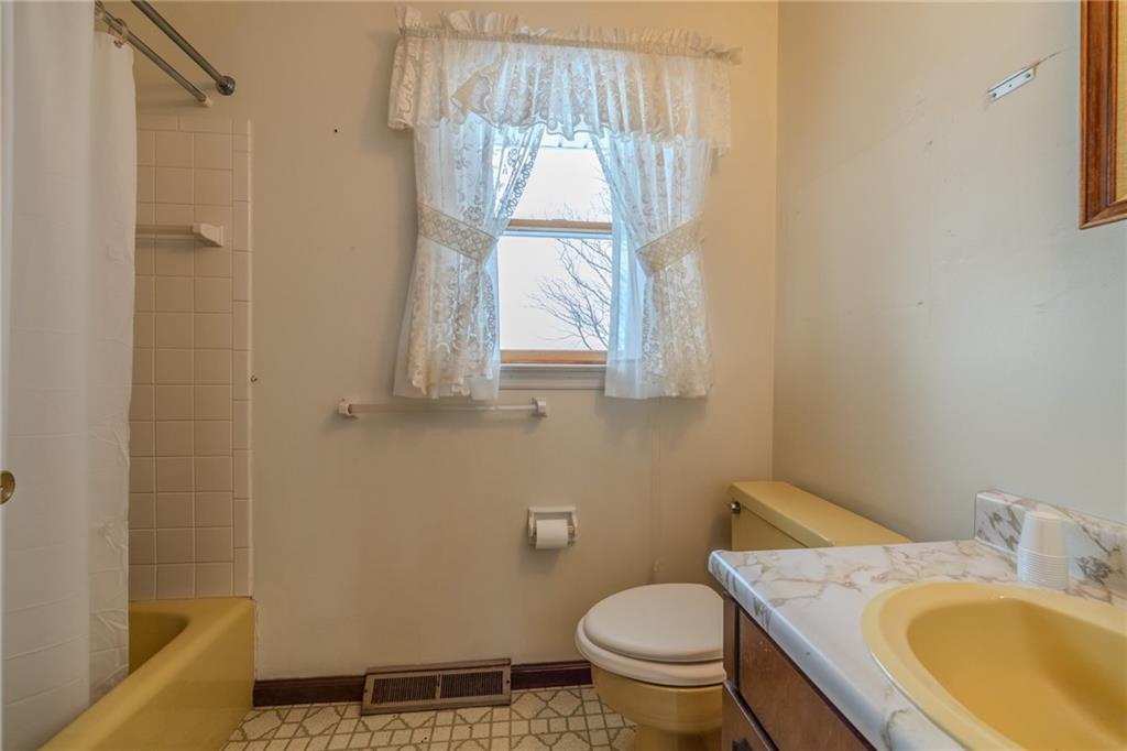 1142 Apples Mill Road West Newton, PA 15089 - Photo 22 of 32 a bathroom with a granite countertop toilet a sink and a window
