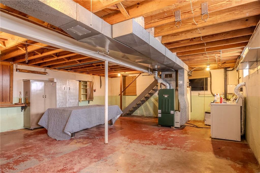 1142 Apples Mill Road West Newton, PA 15089 - Photo 25 of 32 a view of a storage room with stairs and a couch