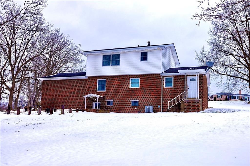 1142 Apples Mill Road West Newton, PA 15089 - Photo 29 of 32 a front view of a house with a yard covered in snow