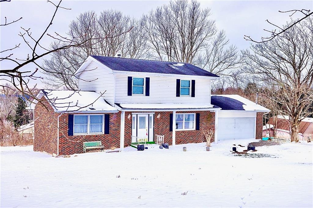 1142 Apples Mill Road West Newton, PA 15089 - Photo 3 of 32 a front view of a house with a yard covered in snow