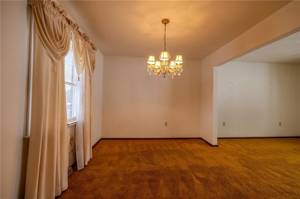 1142 Apples Mill Road West Newton, PA 15089 - Photo 9 of 32 a view of a livingroom with a chandelier curtains and large windows