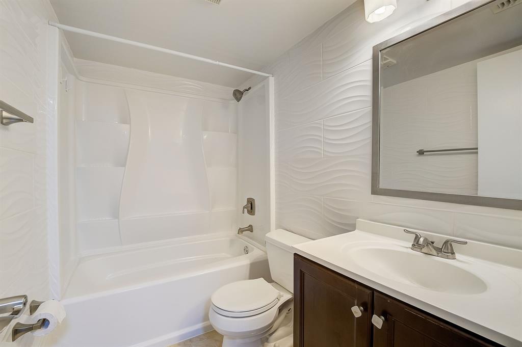 7940 Northwest 50th Street, Unit 203 Lauderhill, FL 33351 - Photo 16 of 36 a bathroom with a sink a toilet and shower