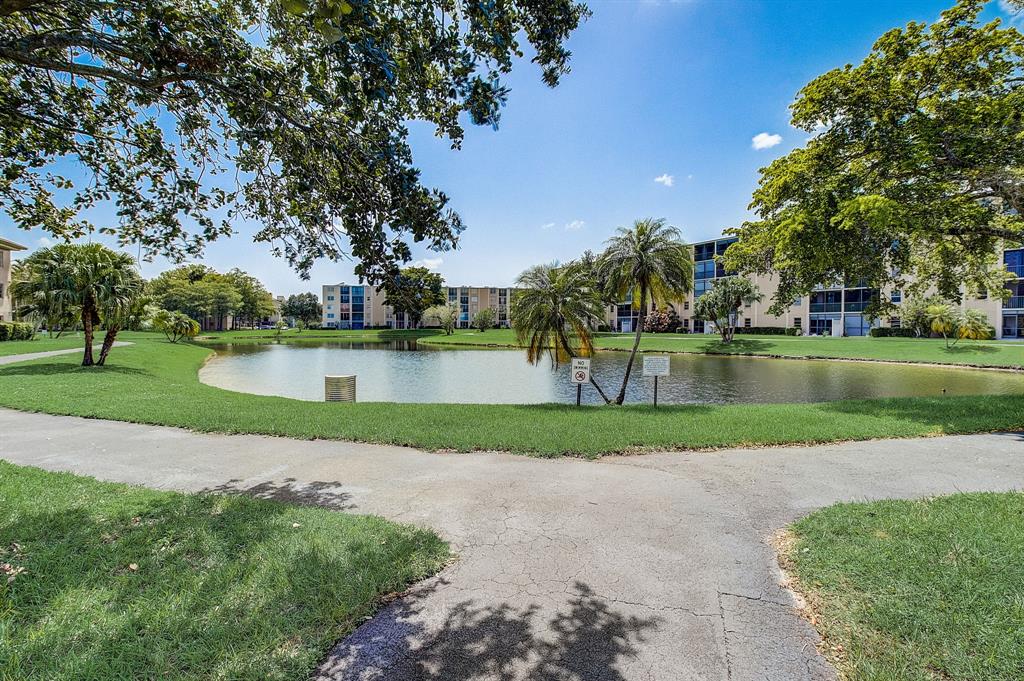 7940 Northwest 50th Street, Unit 203 Lauderhill, FL 33351 - Photo 24 of 36 a view of a park with large trees and plants