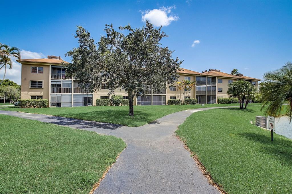 7940 Northwest 50th Street, Unit 203 Lauderhill, FL 33351 - Photo 26 of 36 a view of a house with a yard