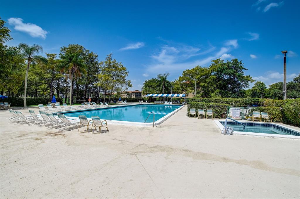 7940 Northwest 50th Street, Unit 203 Lauderhill, FL 33351 - Photo 28 of 36 a view of swimming pool with outdoor seating and plants