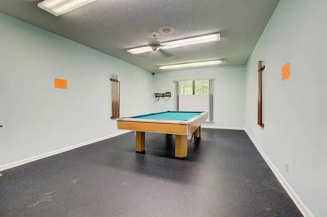 a living room with furniture and a view of kitchen
