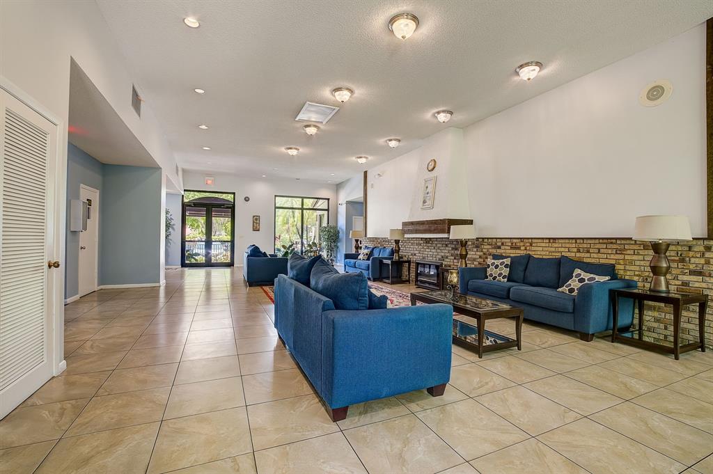 7940 Northwest 50th Street, Unit 203 Lauderhill, FL 33351 - Photo 32 of 36 a living room with furniture and a view of kitchen
