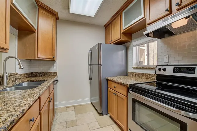 a kitchen that has a sink and a stove