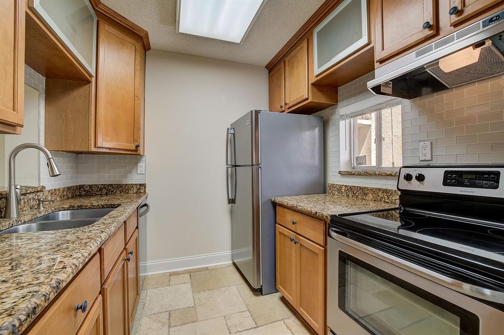 7940 Northwest 50th Street, Unit 203 Lauderhill, FL 33351 - Photo 6 of 36 a kitchen with stainless steel appliances granite countertop a sink stove and refrigerator