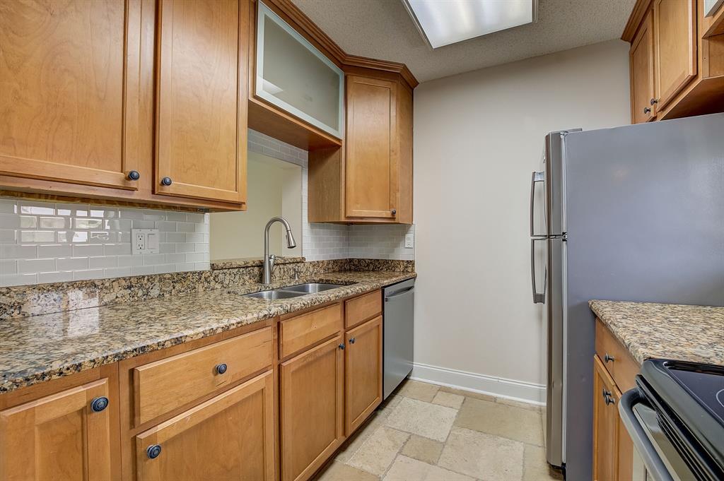 7940 Northwest 50th Street, Unit 203 Lauderhill, FL 33351 - Photo 7 of 36 a kitchen with granite countertop cabinets stainless steel appliances and a counter space