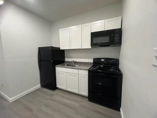 a kitchen with a refrigerator stove and microwave