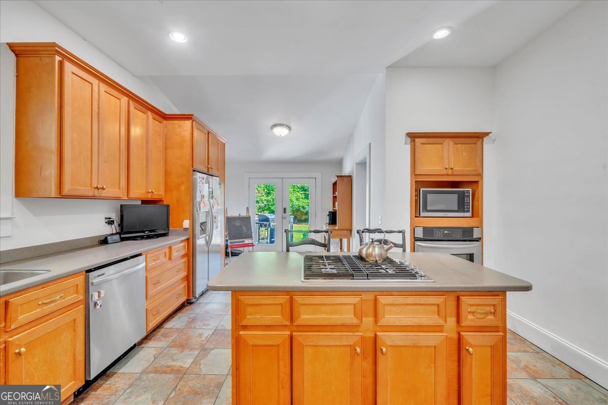 712 Stonewall Street Dublin, GA 31021 - Photo 16 of 65 a kitchen with stainless steel appliances a sink stove and cabinets