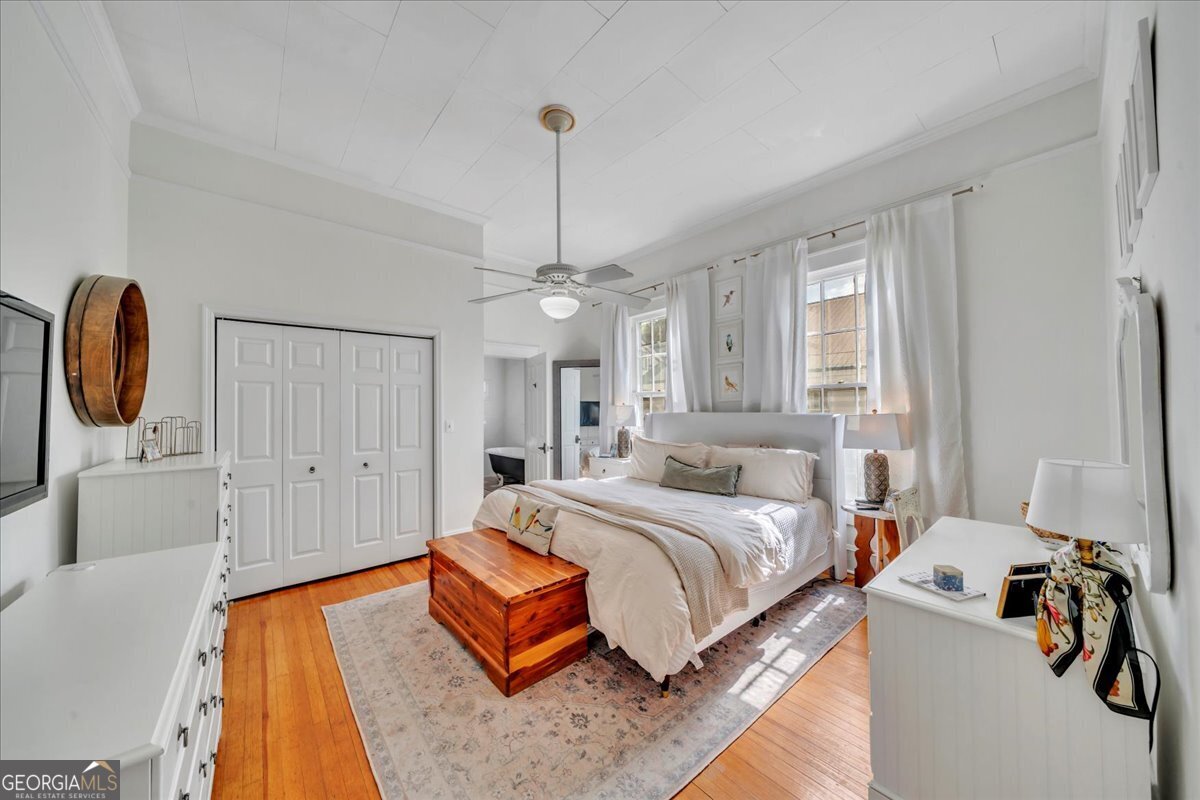 712 Stonewall Street Dublin, GA 31021 - Photo 22 of 65 a bedroom with a bed wooden floor and window