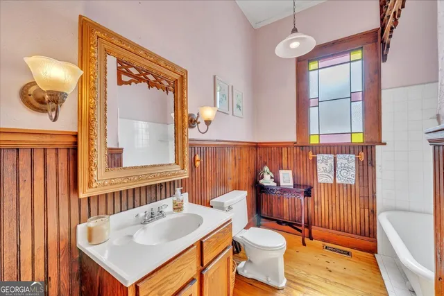 a bedroom with furniture and a wooden floor