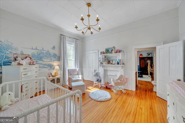 a bedroom with furniture and a chandelier
