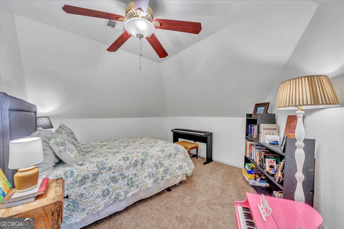 712 Stonewall Street Dublin, GA 31021 - Photo 44 of 65 a bedroom with a bed and a book shelf